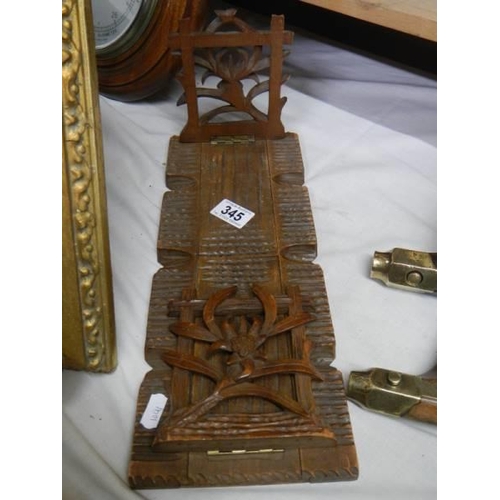 345 - A carved Black Forest style adjustabel book stand.