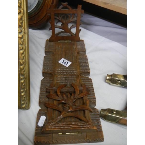 345 - A carved Black Forest style adjustabel book stand.