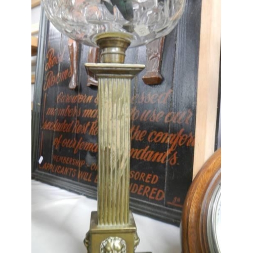 354 - A Victorian oil lamp with brass column, glass font and later shade.