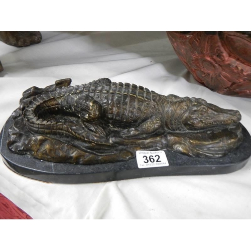 362 - A bronze sleeping crocodile on marble base.