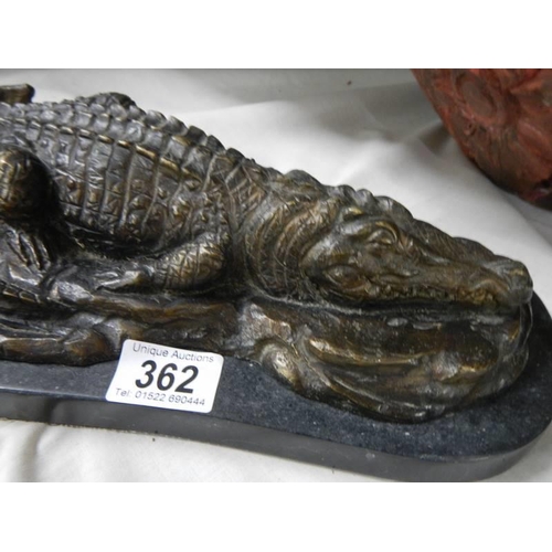 362 - A bronze sleeping crocodile on marble base.