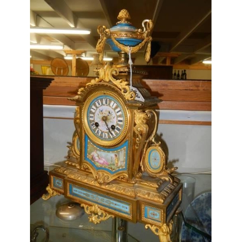 369 - A French ormolu mantel clock with Sevres porcelain panels.