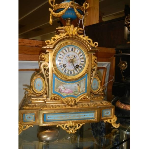 369 - A French ormolu mantel clock with Sevres porcelain panels.