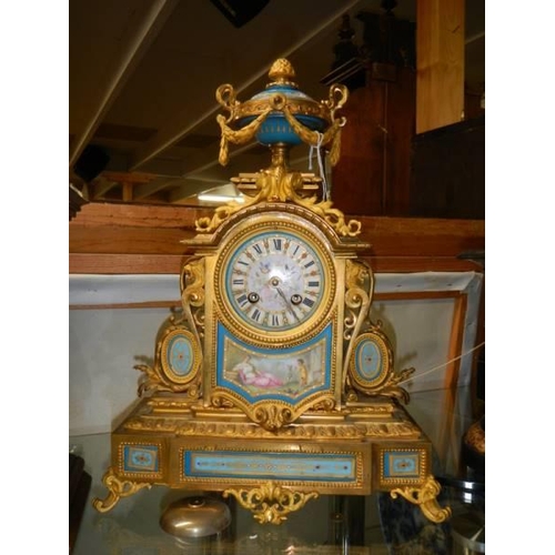 369 - A French ormolu mantel clock with Sevres porcelain panels.