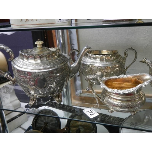 372 - Two silver plate teapots. a milk jug and a sugar bowl.