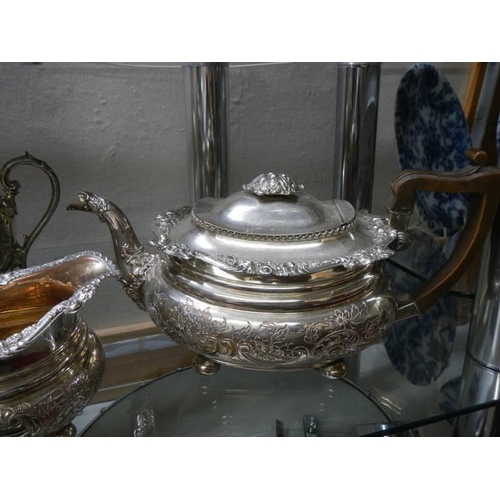 372 - Two silver plate teapots. a milk jug and a sugar bowl.