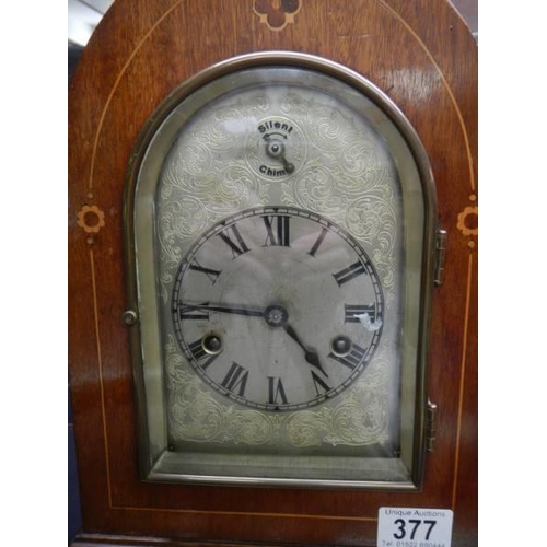 377 - A Victorian arch top inlaid bracket clock with chased silvered dial and Westminster chime,