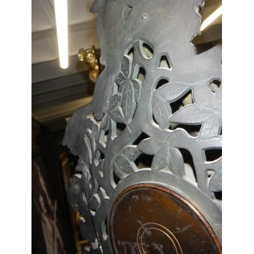 387 - A Victorian cast iron 8 day clock with bronzed finish featuring horse, rider, dogs etc.,