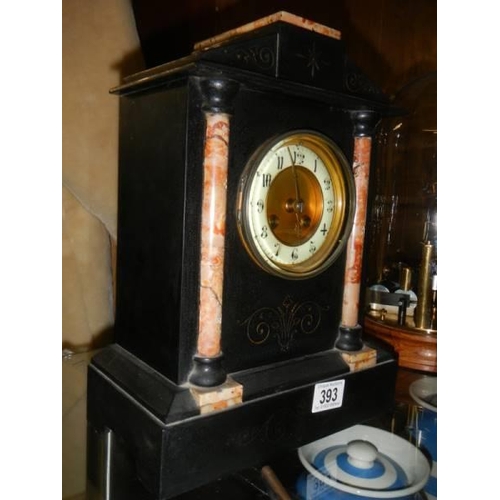 393 - A black slate/marble mantel clock.