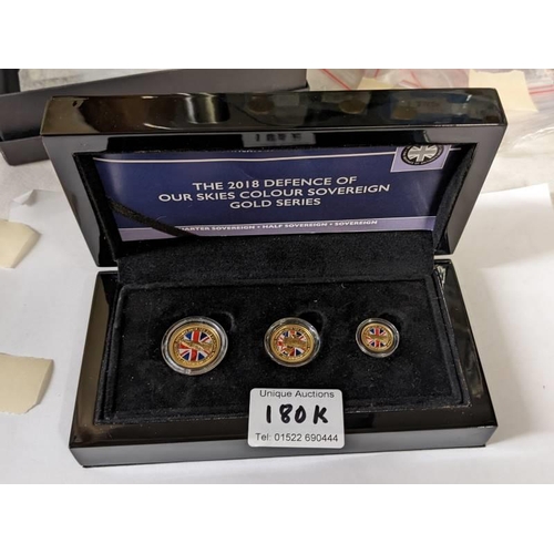 180K - A cased The 2018 Defence of our Skies colour sovereign gold series containing quarter sovereign, hal... 