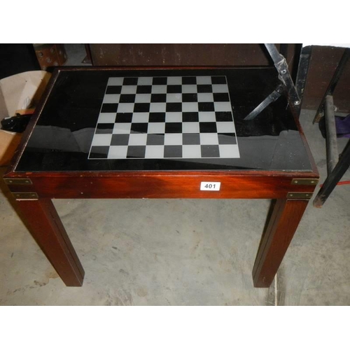 401 - A chess table with glass top and storage compartment with contents.