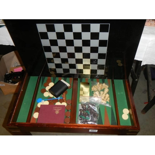 401 - A chess table with glass top and storage compartment with contents.