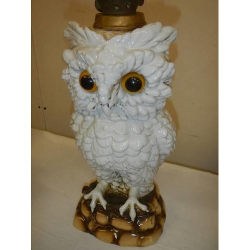 439 - A ceramic oil lamp in the form of an owl with crossed swords mark.