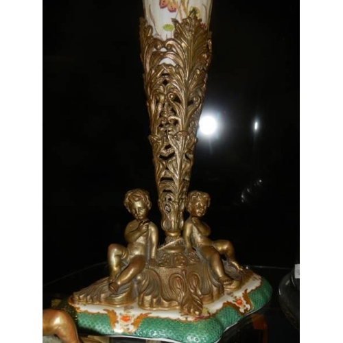 447 - A pair of large 41cm vases on bronze cherub bases.