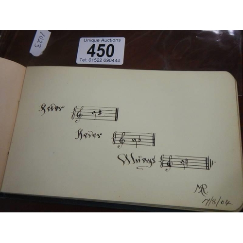 450 - An early 20th century autograph book containing verses and drawings.