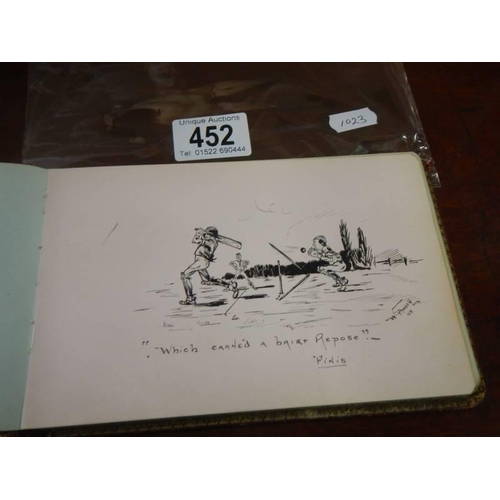 452 - An early 20th century autograph book containing verses and drawings.