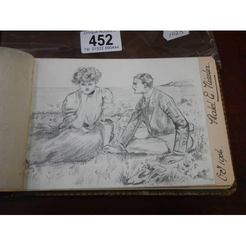 452 - An early 20th century autograph book containing verses and drawings.