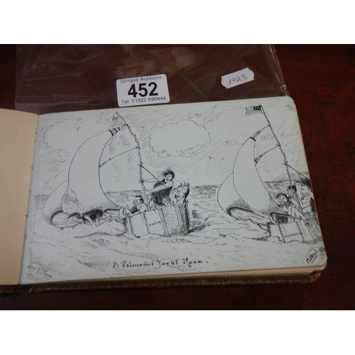 452 - An early 20th century autograph book containing verses and drawings.