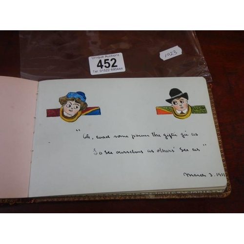 452 - An early 20th century autograph book containing verses and drawings.