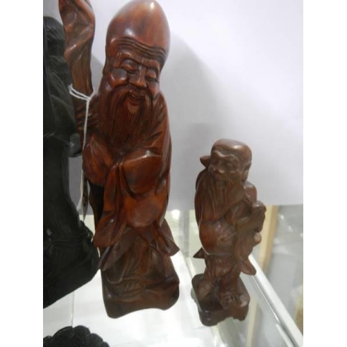 465 - Three carved wood figures and a mask.