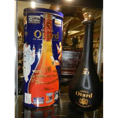 493 - A bottle of cognac Otard in original tin.