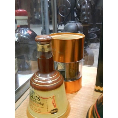 500 - Two Bell's whisky bells with contents, a Glayva Scotch liquor and other whisky.