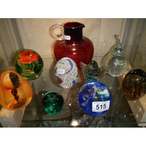 515 - A good lot of glass paperweights.