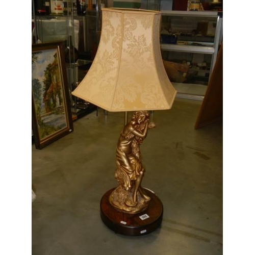 588 - A spelter figural table lamp with shade.