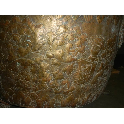 594 - A large embossed brass log bin, 44 cm tall x 62 cm diameter.