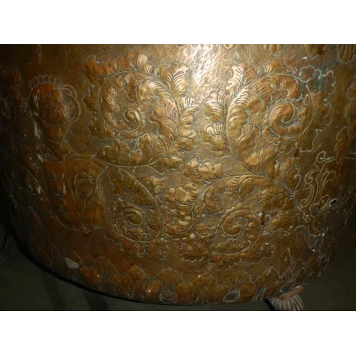 594 - A large embossed brass log bin, 44 cm tall x 62 cm diameter.