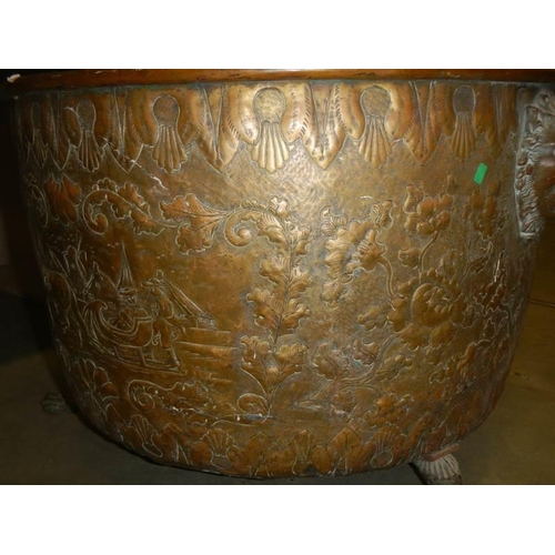 594 - A large embossed brass log bin, 44 cm tall x 62 cm diameter.