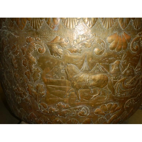 594 - A large embossed brass log bin, 44 cm tall x 62 cm diameter.