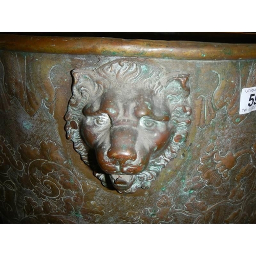 594 - A large embossed brass log bin, 44 cm tall x 62 cm diameter.