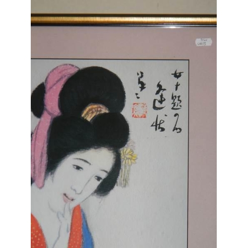 604 - A 20th century Japanese print of a young lady holding a scroll, 48 x 61 cm.