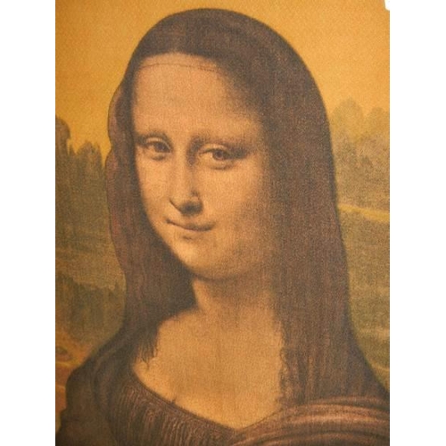 635 - A framed print on silk of the Mona Lisa. 74 x 49 cm.