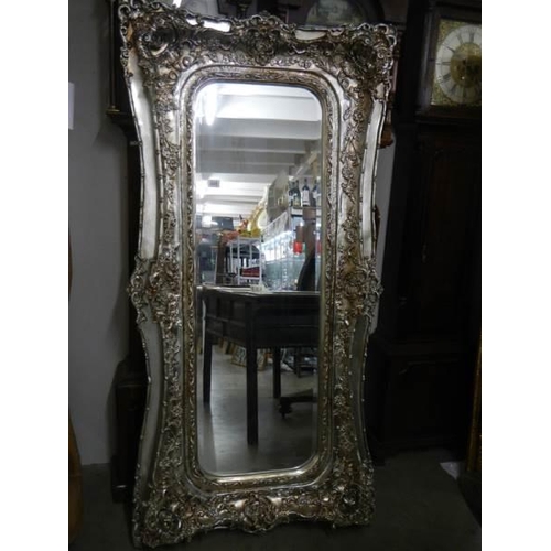 649 - A large mirror in silvered frame, 180 x 90 cm.