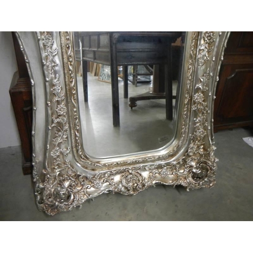 649 - A large mirror in silvered frame, 180 x 90 cm.