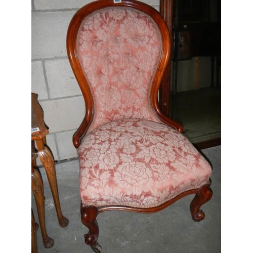 660 - A Victorian mahogany nursing chair on cabriole legs.