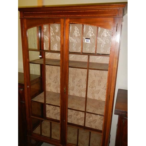 663 - An Edwardian two door display cabinet.