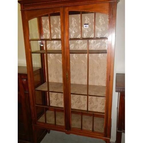 663 - An Edwardian two door display cabinet.