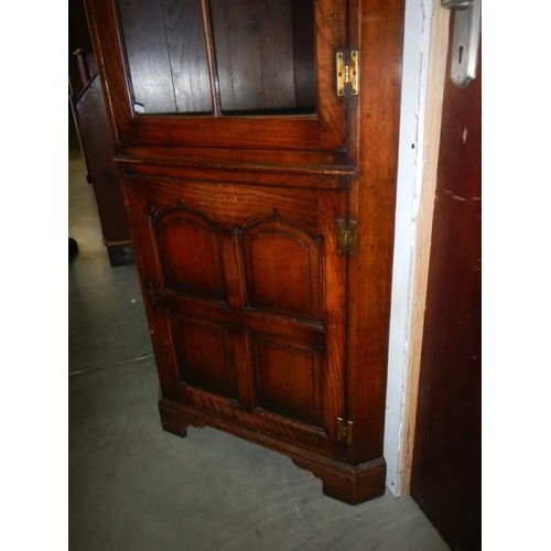 671 - A good quality oak corner cupboard.