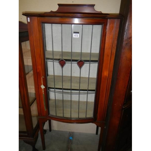 672 - A mahogany inlaid single door display cabinet.