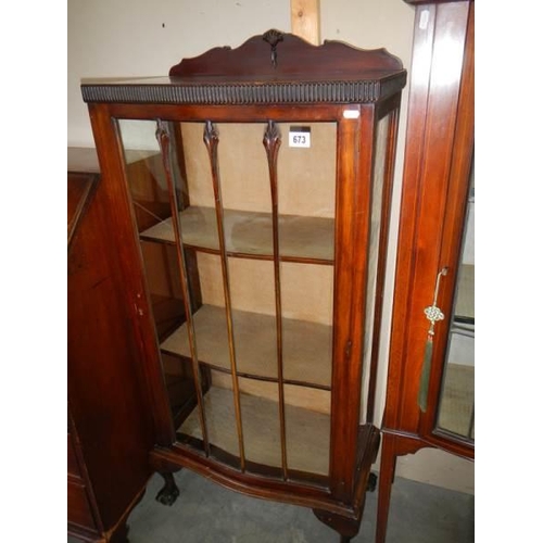 673 - A mahogany single door display cabinet.