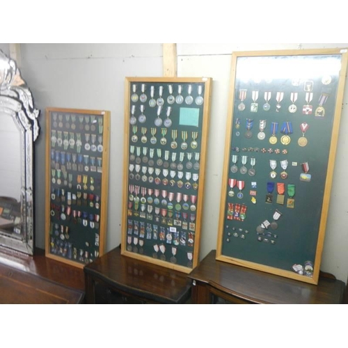 681 - Three framed and glazed cases of various medals. COLLECT ONLY.