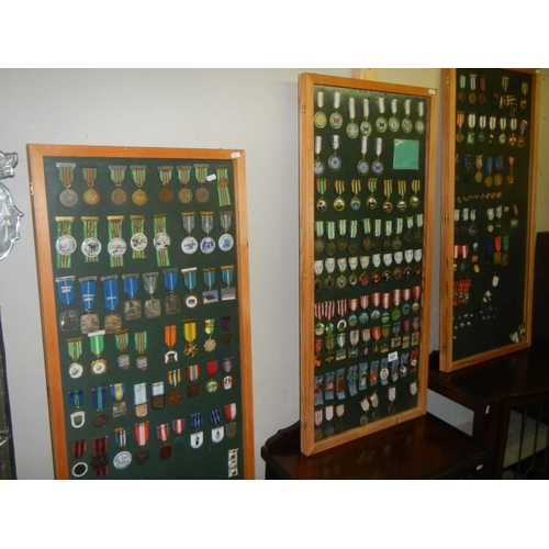 681 - Three framed and glazed cases of various medals. COLLECT ONLY.