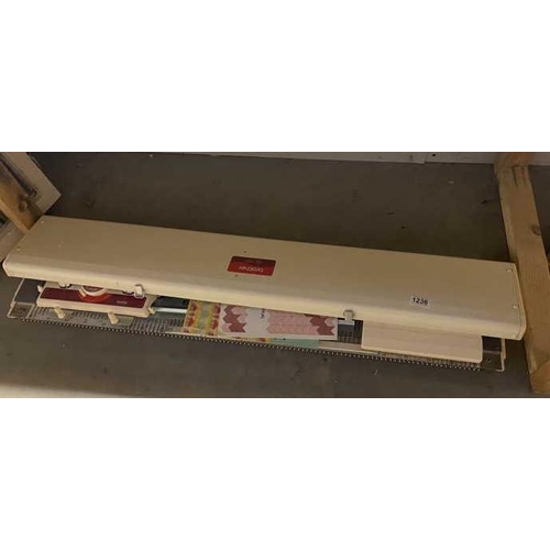 1236 - A vintage Brother knitting machine with manuals (model KH-230)