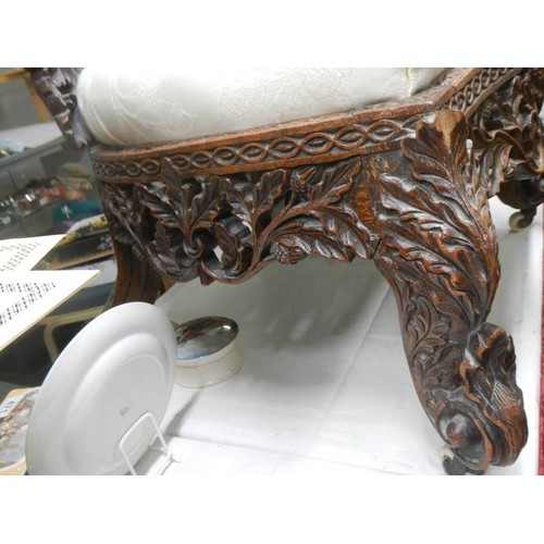 462 - An early heavily carved Burmese chair. COLLECT ONLY.