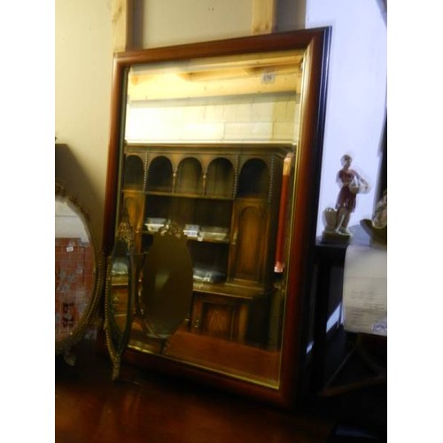 679 - A mahogany framed bevel edged mirror.