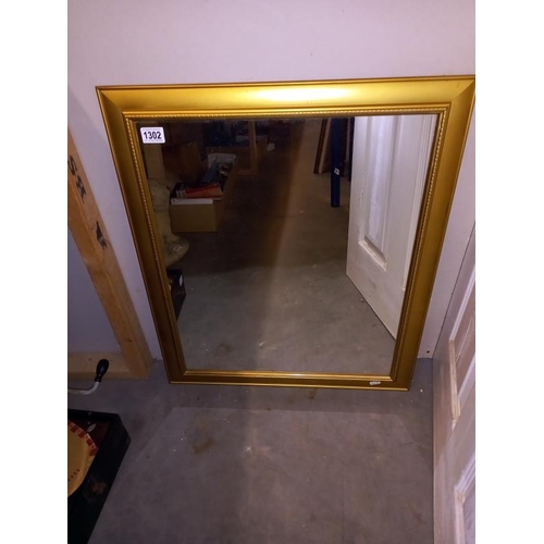 1302 - A gilt framed mirror - 61cm x 71cm (COLLECT ONLY)