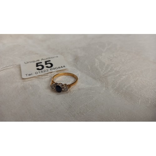 55 - A diamond and sapphire three stone ring, stamped 18ct platinum, size L, 2.6 grams.